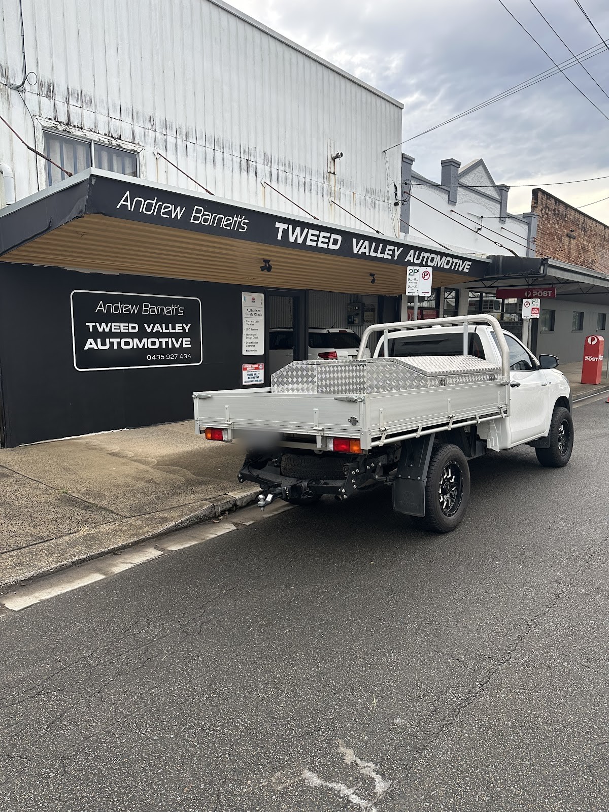 The black Tweed Valley Automotive shopfront with its Authorised Safety Check plate beside the door